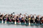 photo of a competative team rowing a dragon boat