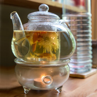 clear glass teapot with soothing floral loose tea